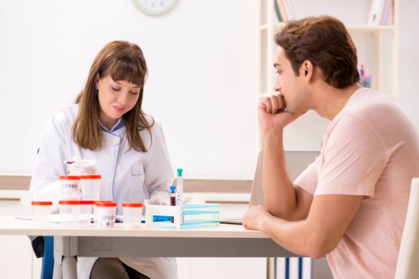 Homem em consulta médica para doação de sêmen.